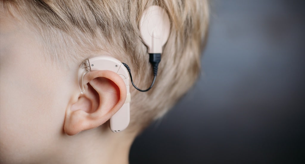 EO residual limits. Close picture of a child using an ear device