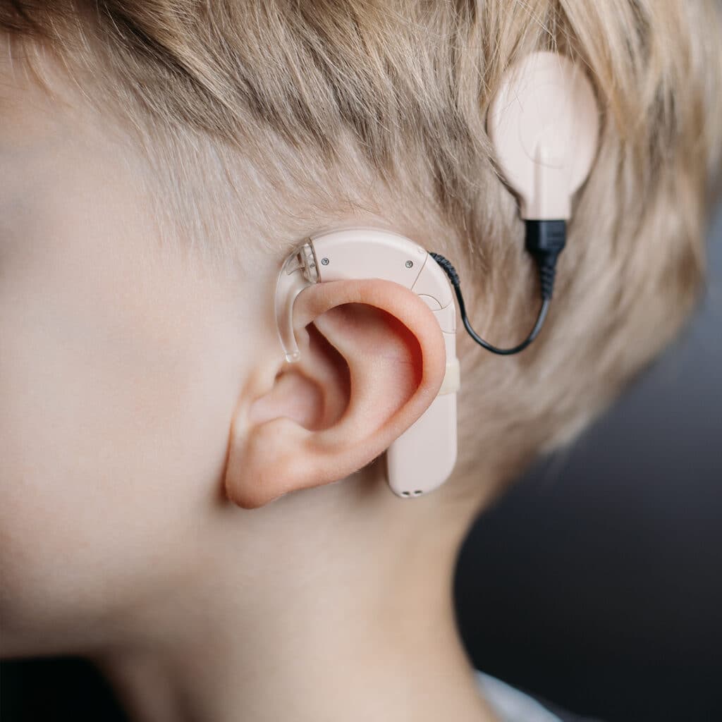 Close picture of a child using an ear device