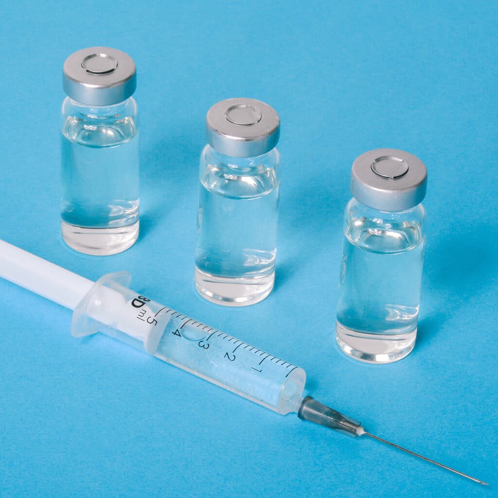 Picture of three vials and a syringe on a light blue background. How does the FDA classify medical devices. FDA classifications for medical devices. Regulatory controls for medical devices. Premarket approval submission for FDA marketing. FDA product classification. How to determine FDA classification for medical devices