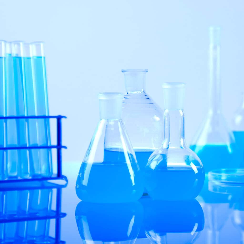 Picture of several test tubes and flasks on a laboratory table with a blue background. In-vitro cytotoxicity testing. In-vitro cytotoxicity testing usp 87. In-vivo cytotoxicity testing. In-vivo cytotoxicity testing usp 88. In-vitro tests usp 87 guidelines. In-vivo tests usp 88 guidelines. Intramuscular implantation in rabbits. Intramuscular implantation in rats