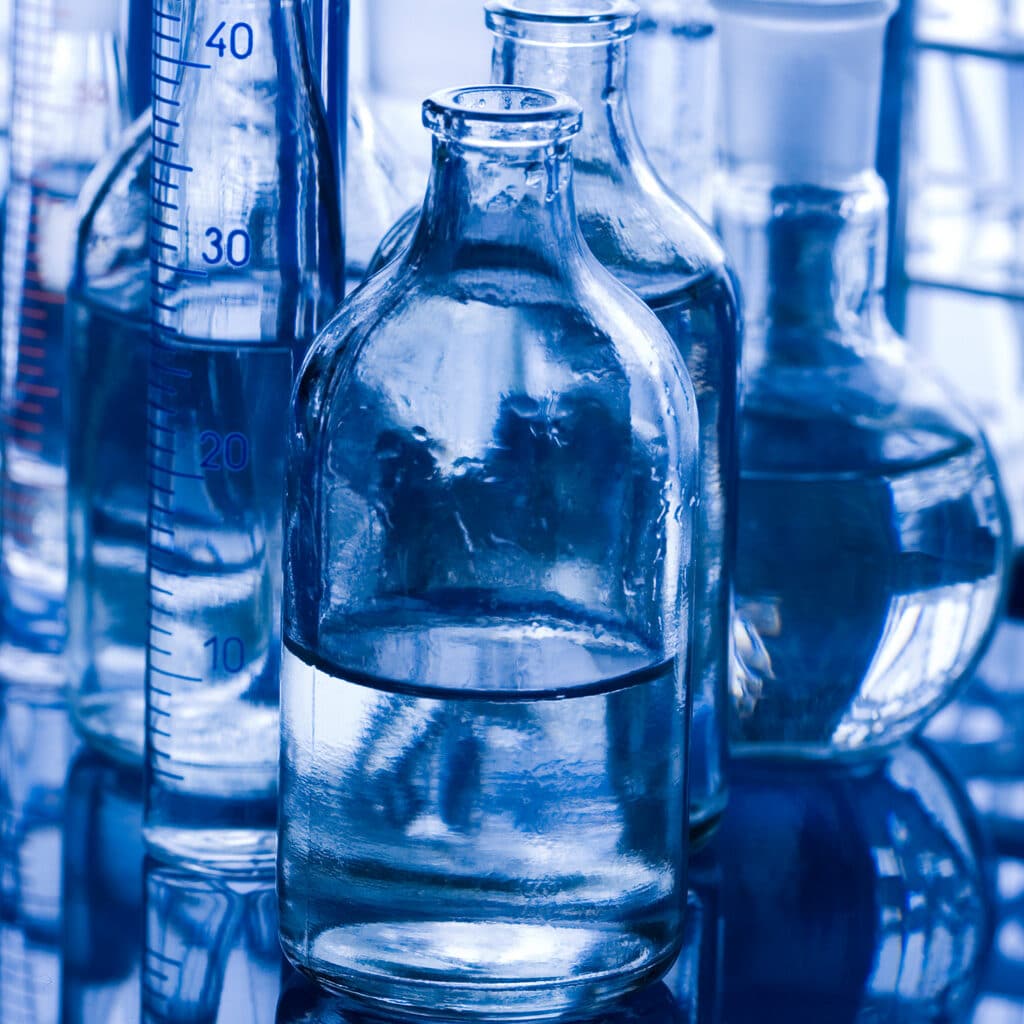 Several test tubes and flasks on a laboratory table in a blue background. How is eto residuals testing performed. Eto residuals testing. Eto sterilization. Eo sterilization. Simulated-use extraction measuring methods. Simulated-use measuring methods. Exhaustive extraction measuring methods. Exhaustive extraction methods. Calculations for eto residuals. Calculations for eo residuals